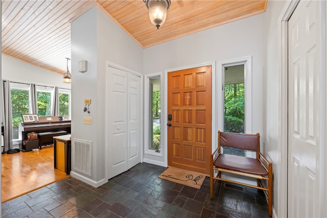entrance foyer with wooden ceiling, stone tile floors, and plenty of natural light