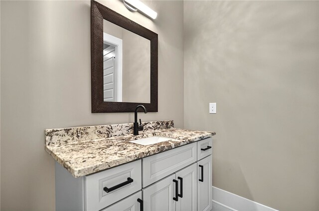 bathroom featuring baseboards and vanity