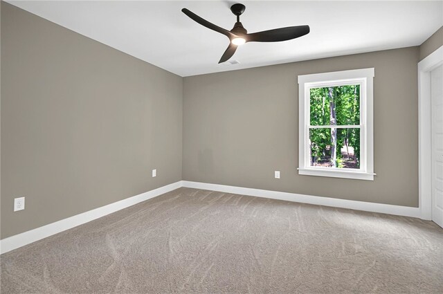 unfurnished room with baseboards, a ceiling fan, and carpet flooring