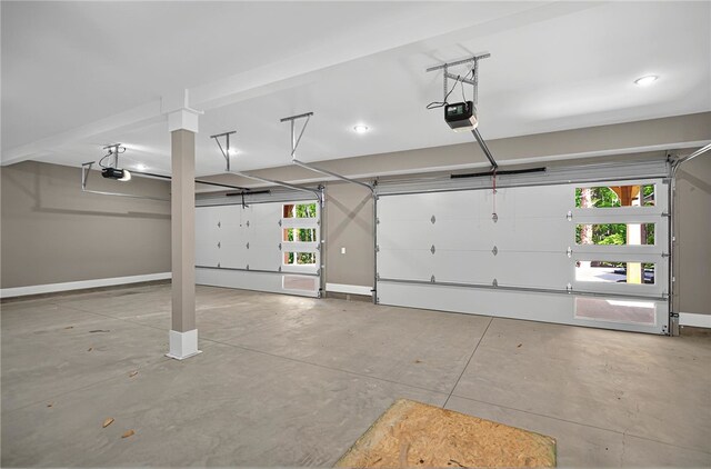 garage with baseboards and a garage door opener