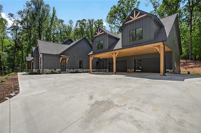 modern farmhouse style home with concrete driveway, an attached garage, and board and batten siding
