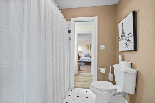 full bath featuring tile patterned floors and toilet