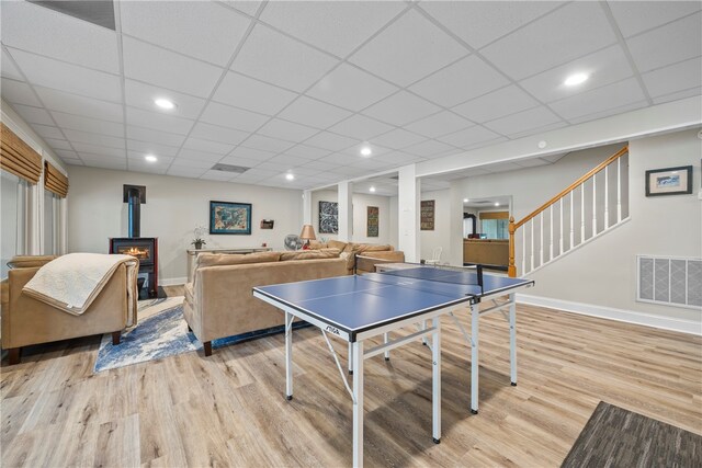 playroom featuring a paneled ceiling, visible vents, and light wood-type flooring