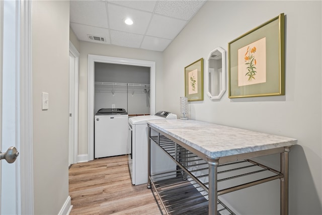 washroom featuring recessed lighting, light wood-style flooring, washing machine and dryer, baseboards, and visible vents