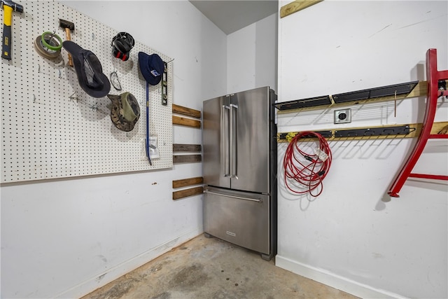 interior space with baseboards and concrete floors