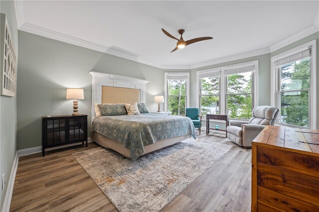 bedroom featuring ornamental molding and wood finished floors