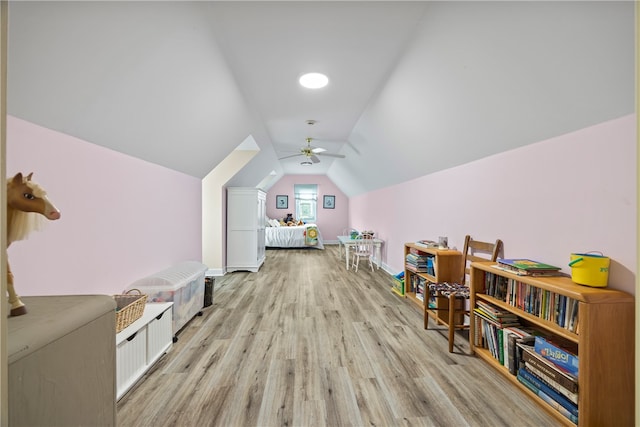 rec room with light wood finished floors, ceiling fan, lofted ceiling, and baseboards