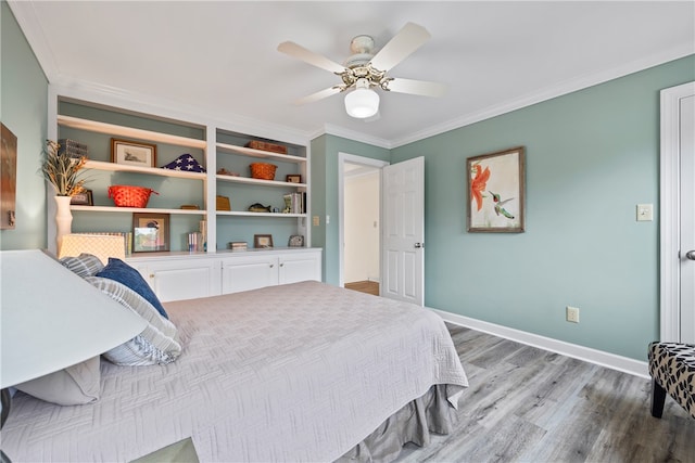 bedroom with wood finished floors, ceiling fan, crown molding, and baseboards