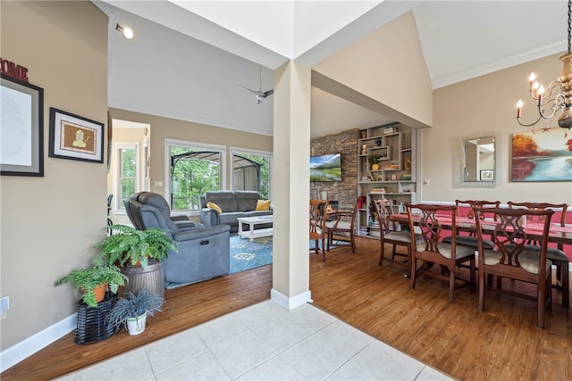 dining room with baseboards, a notable chandelier, and tile patterned flooring