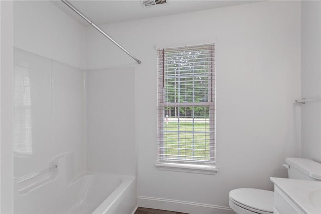 full bath featuring vanity, bathing tub / shower combination, toilet, visible vents, and baseboards