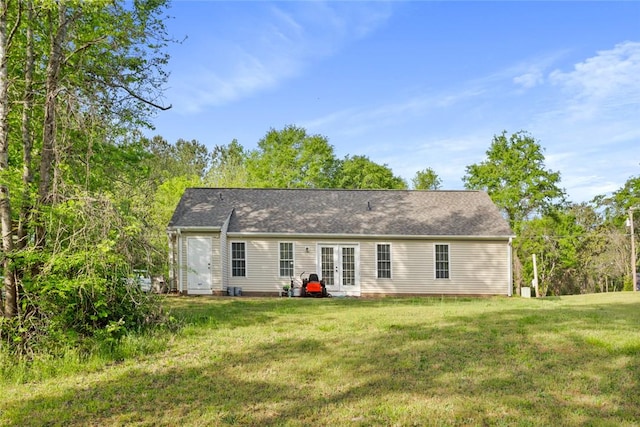 rear view of house featuring a yard and french doors