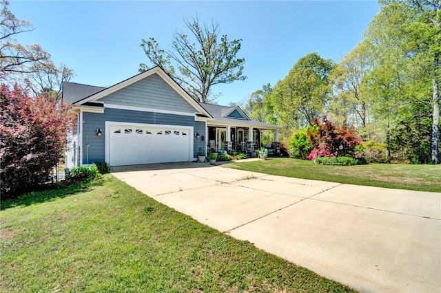 view of front facade featuring a porch, a front yard, an attached garage, and concrete driveway