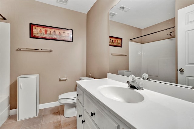 bathroom featuring vanity, toilet, visible vents, baseboards, and walk in shower