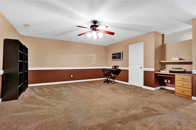 office area with baseboards, visible vents, a ceiling fan, and carpet floors