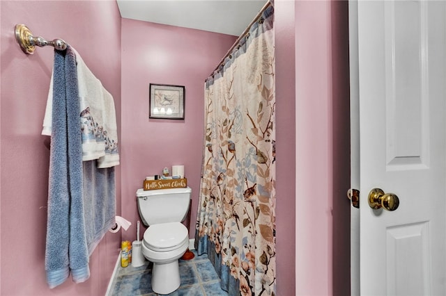 bathroom featuring toilet, a shower with shower curtain, and tile patterned flooring