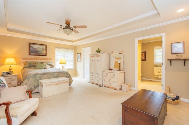 bedroom featuring multiple windows and a tray ceiling