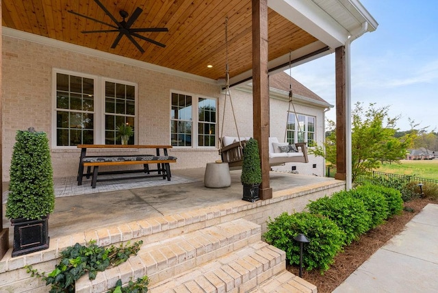 view of patio / terrace with fence and a ceiling fan