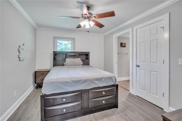 bedroom with crown molding, a ceiling fan, wood finished floors, and baseboards