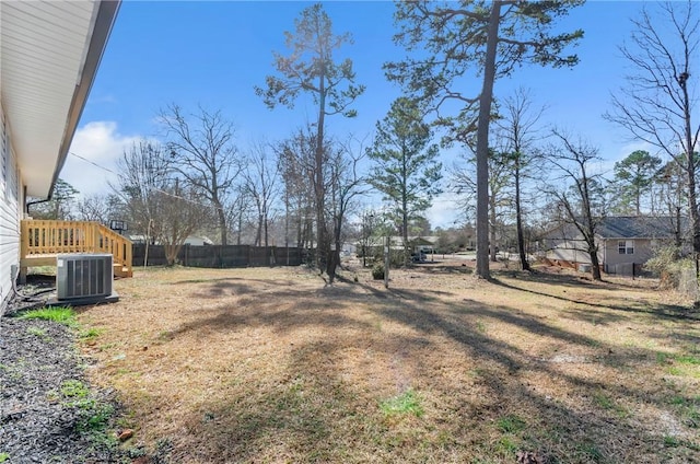 view of yard featuring fence and central AC unit