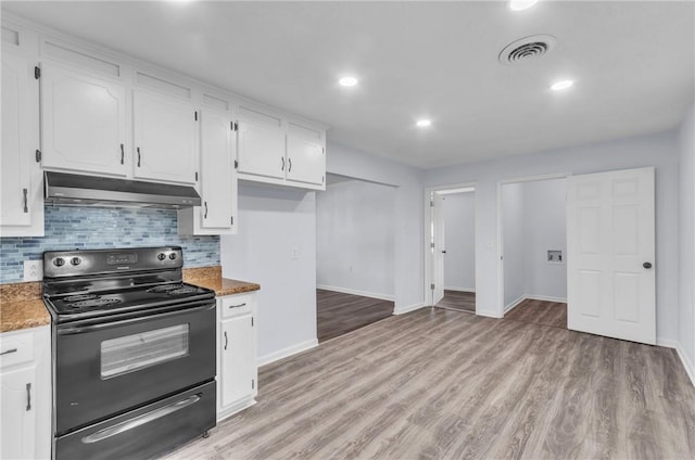 kitchen featuring white cabinets, black range with electric stovetop, under cabinet range hood, and baseboards