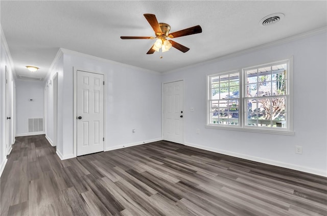 unfurnished bedroom with dark wood-style flooring, visible vents, and crown molding
