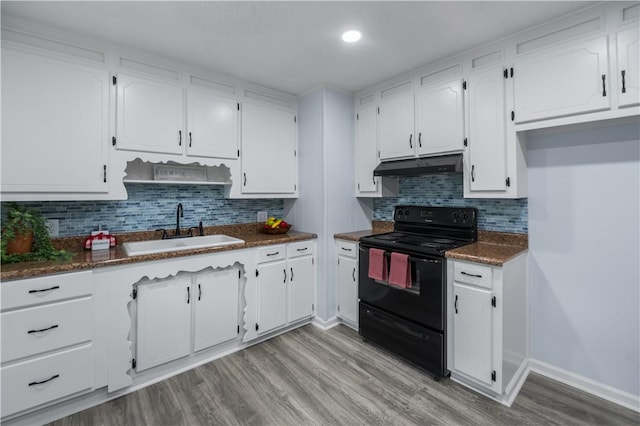 1004 Gilreath Rd, Anderson, SC 29621 - kitchen featuring black range with electric cooktop, a sink, under cabinet range hood, dark countertops, and white cabinets