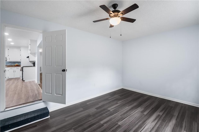 1004 Gilreath Rd, Anderson, SC 29621 - unfurnished room featuring dark wood-type flooring, a ceiling fan, and baseboards