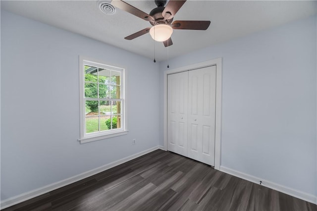 1004 Gilreath Rd, Anderson, SC 29621 - unfurnished bedroom featuring dark wood-type flooring, baseboards, a closet, and ceiling fan