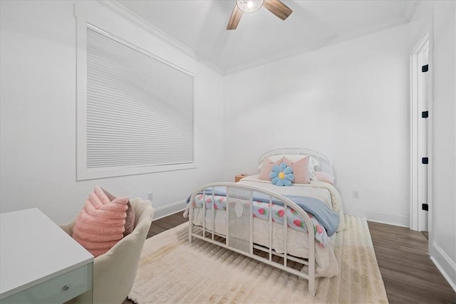 bedroom featuring wood finished floors, ceiling fan, crown molding, and baseboards