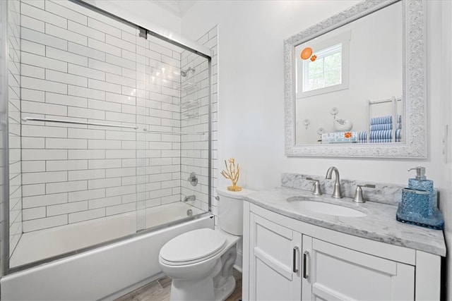 full bathroom with shower / bath combination with glass door, wood finished floors, toilet, and vanity
