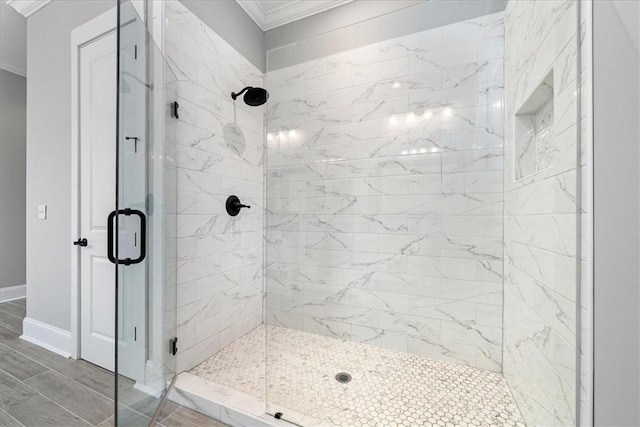 bathroom featuring ornamental molding, a stall shower, and baseboards