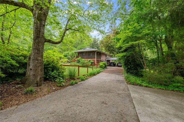 view of community featuring driveway and a forest view
