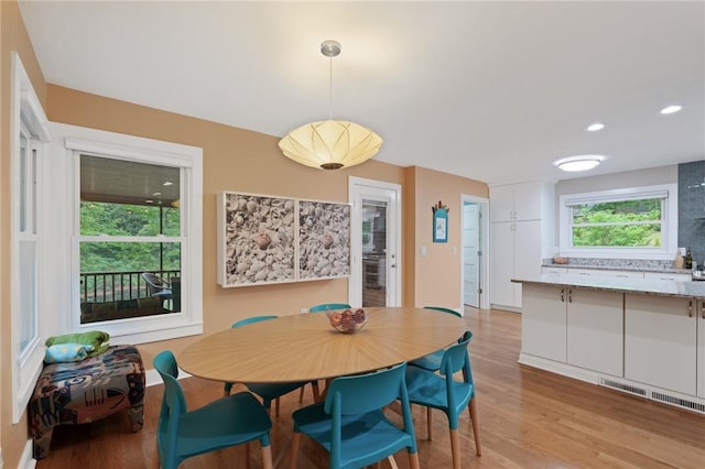 dining area featuring visible vents, light wood finished floors, and recessed lighting