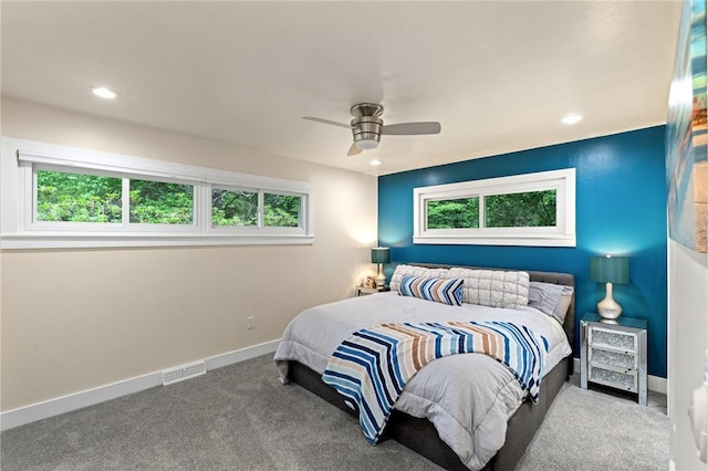 carpeted bedroom with baseboards, recessed lighting, a ceiling fan, and multiple windows