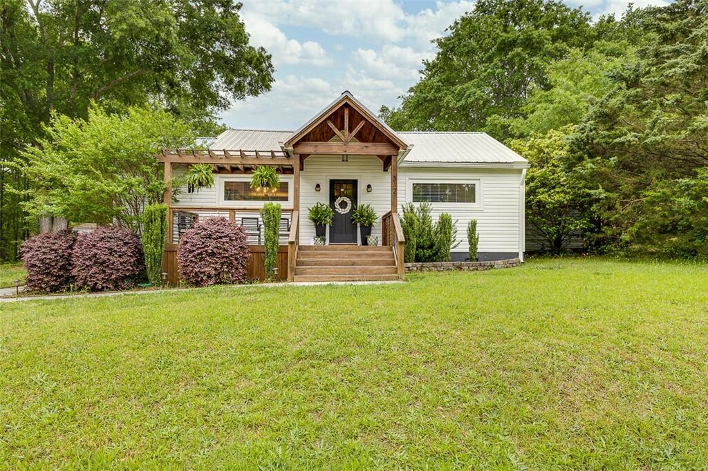 312 Harris Ave, Belton, SC 29627 - view of front facade featuring metal roof, a front yard, and a pergola