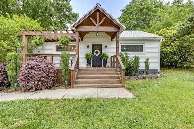 view of front facade featuring a pergola, a front yard, and metal roof