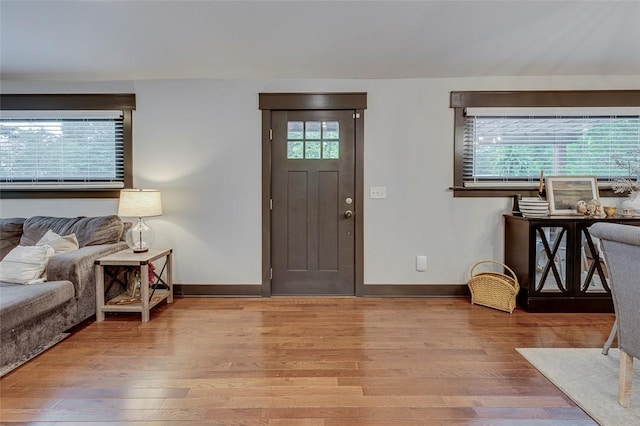 foyer entrance featuring wood finished floors and baseboards