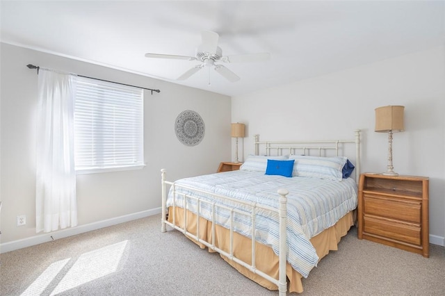 bedroom featuring baseboards, a ceiling fan, and carpet