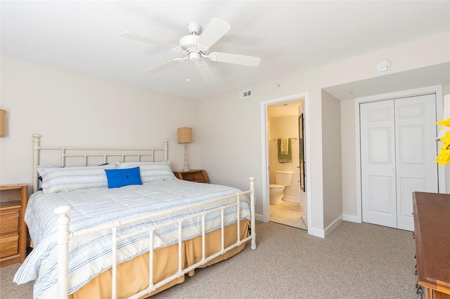 bedroom with visible vents, ceiling fan, a closet, baseboards, and light carpet