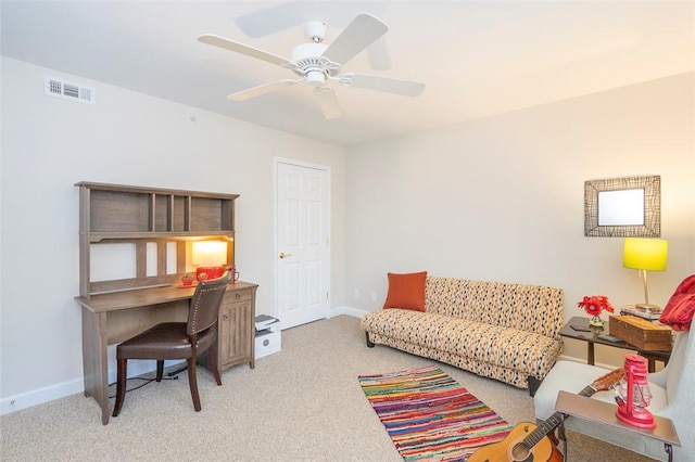 office space with carpet, visible vents, a ceiling fan, and baseboards