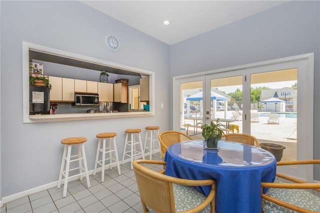dining space featuring baseboards, recessed lighting, light tile patterned floors, and french doors