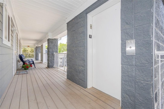 wooden deck featuring a porch and elevator