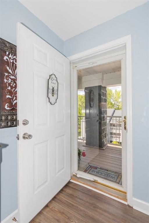 entryway with wood finished floors and baseboards