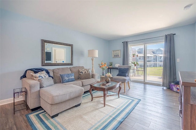 living room with wood finished floors and baseboards
