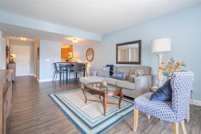 living area featuring wood finished floors and baseboards