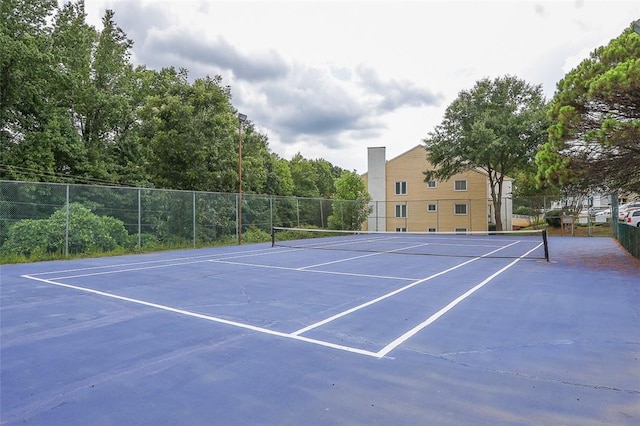 view of tennis court featuring fence