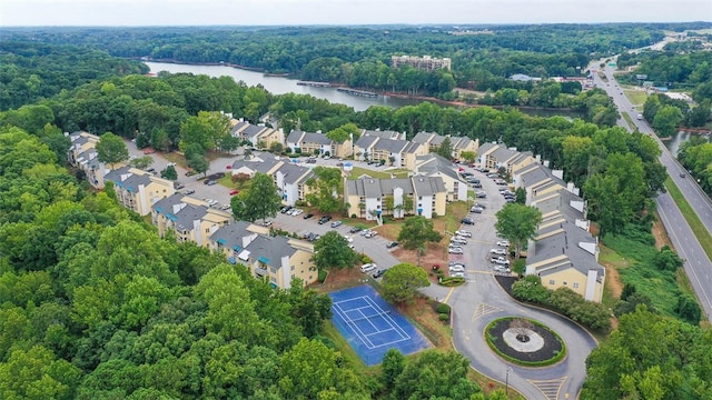 drone / aerial view with a water view and a view of trees