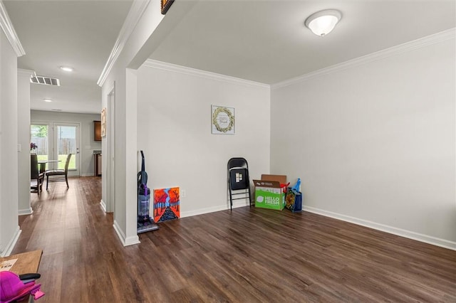 playroom with dark wood-style floors, baseboards, and crown molding