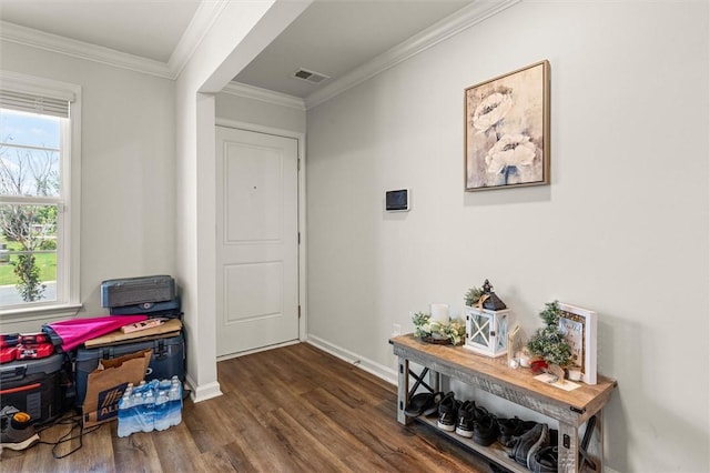 interior space with ornamental molding, dark wood-style floors, visible vents, and baseboards
