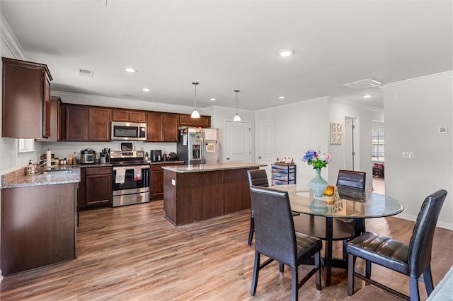 dining space with visible vents, recessed lighting, ornamental molding, and light wood finished floors